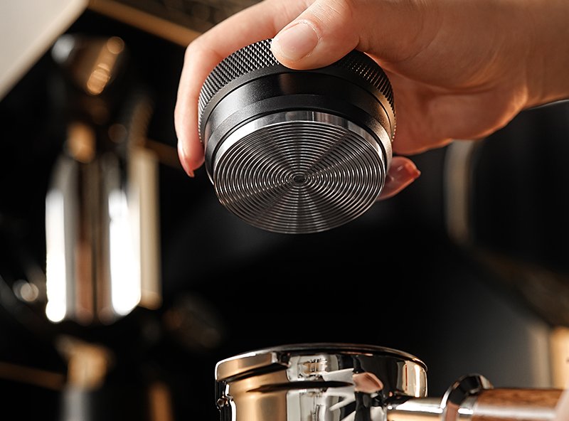 Adjustment ring and grooved stainless-steel base of the MHW-3BOMBER CD tamper