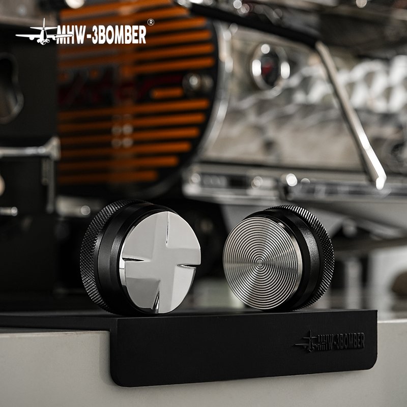 The four surfaces of the CD distributor beside the circular grooves of the CD tamper